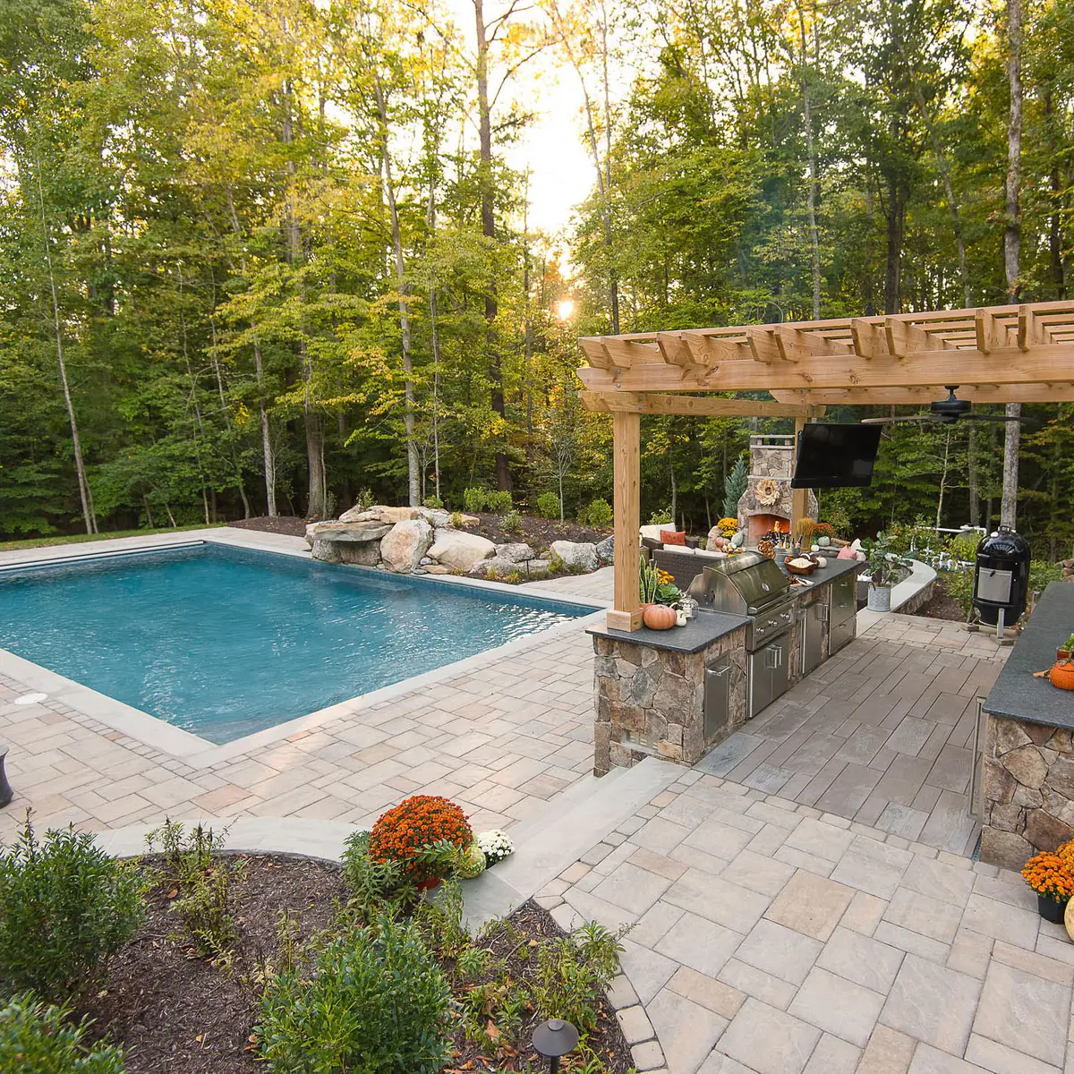 Beautiful outdoor space designed with pergola, kitchen and pool