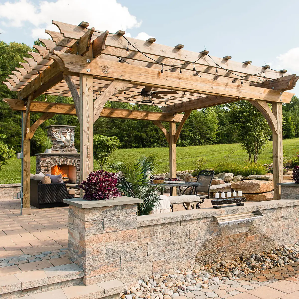 Paver patio with pergola, wall fountain, sitting walls, pillars, and outdoor fireplace