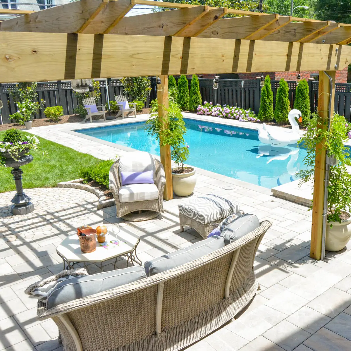 Installed Pergola over outdoor patio seating area with Pool nearby