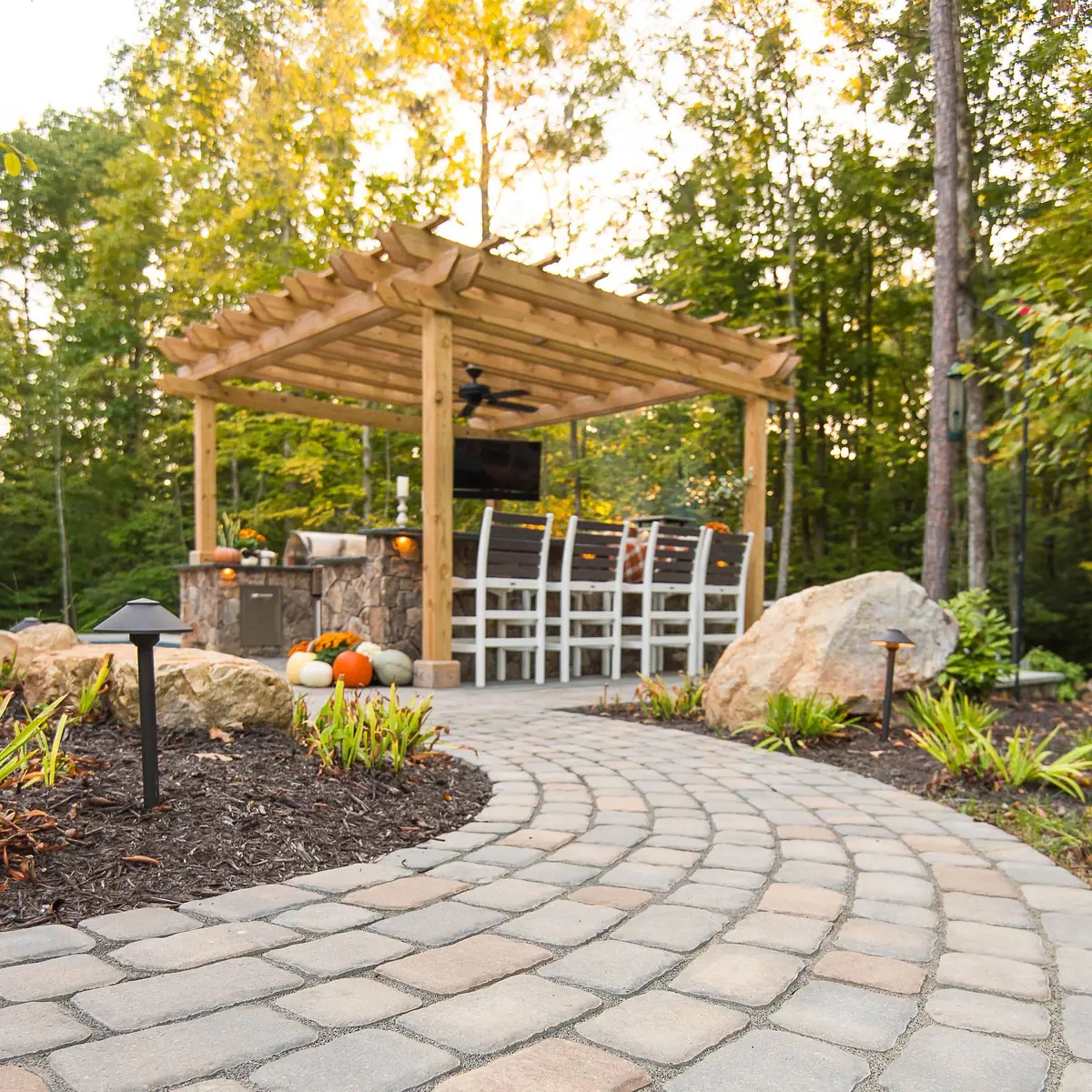 Natural stone paver outdoor path leading to pergola