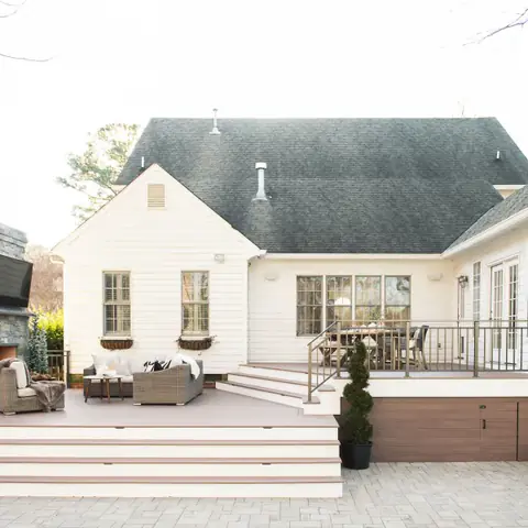 backyard deck and patio connected to cream house