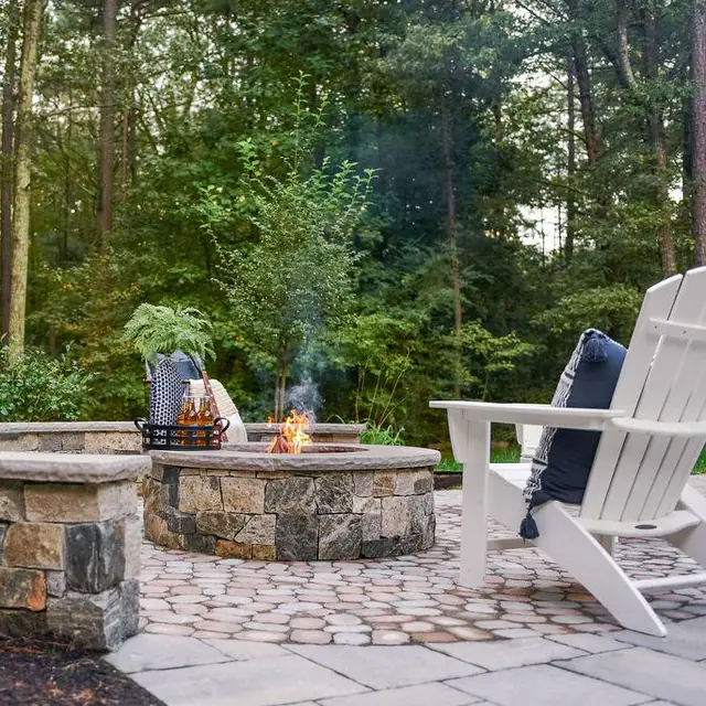 paver patio with stone veneer fire pit and sitting wall